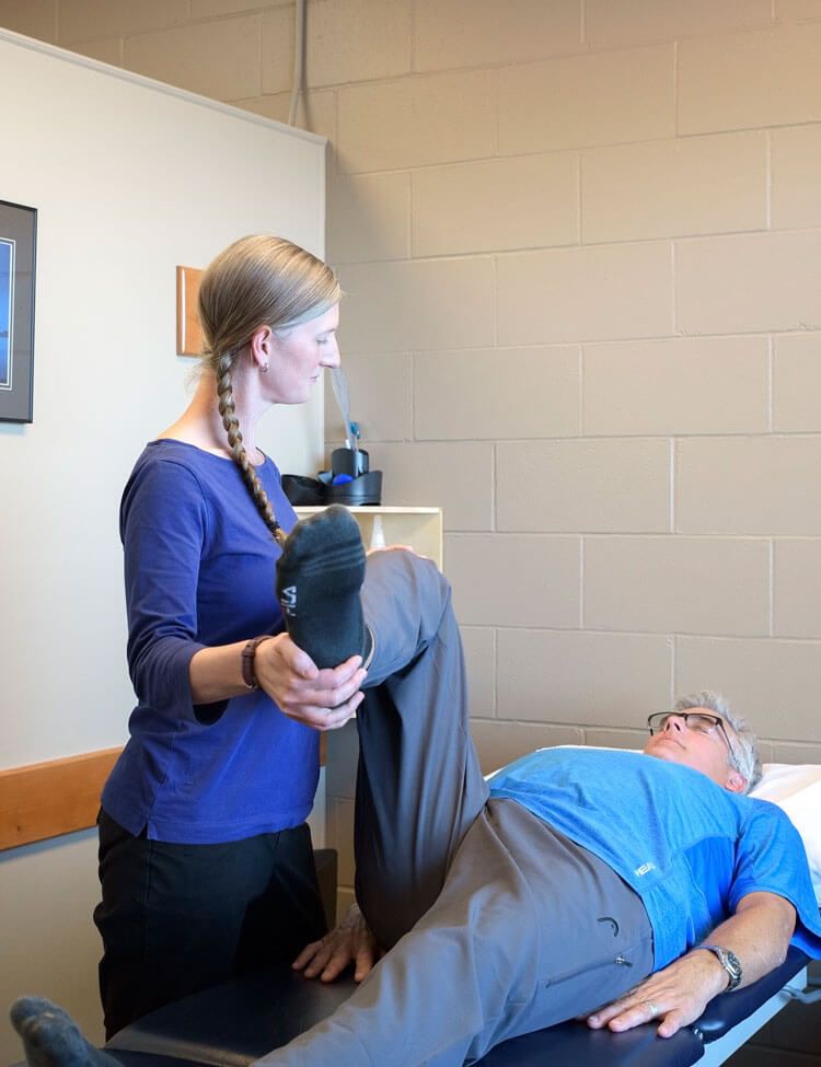Oceanside Physiotherapist helping client with leg injury